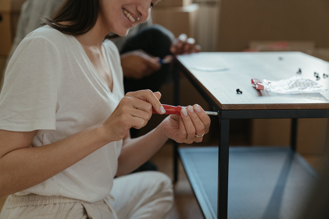 Woman in White Crew Neck T-shirt Holding Red and White Plastic Toy